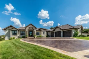 Modern house with spacious driveway and lawn.