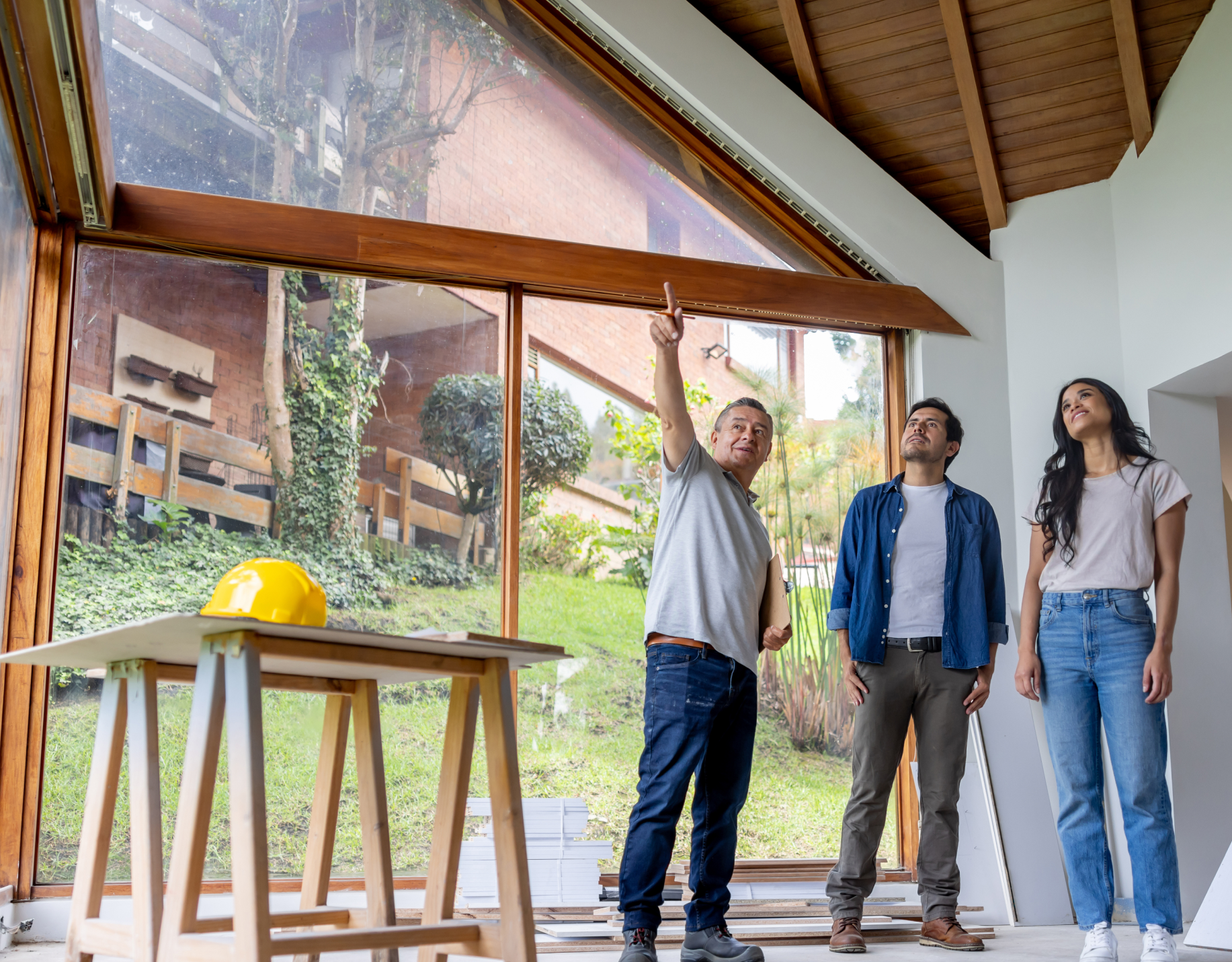 Man showing house interior to couple.