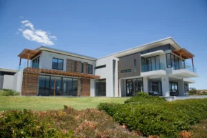 Modern two-story house with large windows.