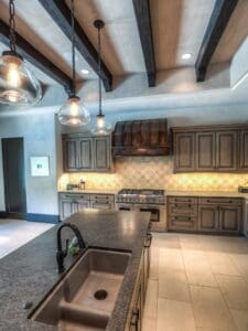 Spacious kitchen featuring stone countertops and sink
