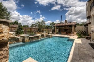 Luxury pool and patio under blue sky