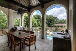 Covered patio overlooking pool and garden