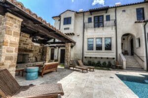 Elegant home exterior with poolside seating