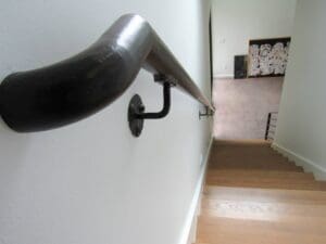 View down wooden stairs with handrail