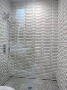Modern bathroom with textured white tiles