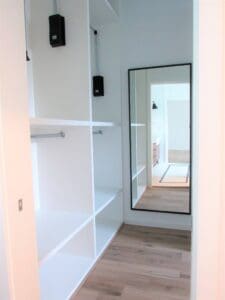 Minimalist closet with wooden floor