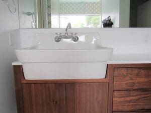 White sink with wooden cabinet