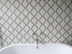 Ornate bathroom tiles with bathtub faucet