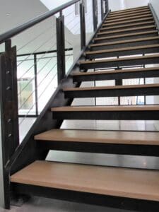 Modern wooden staircase with metal railing