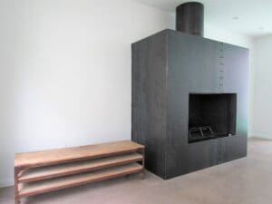 Contemporary fireplace next to wooden bench