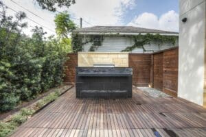 Contemporary barbecue setup in fenced yard