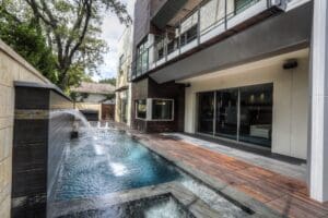 Luxurious patio overlooking a sleek pool.