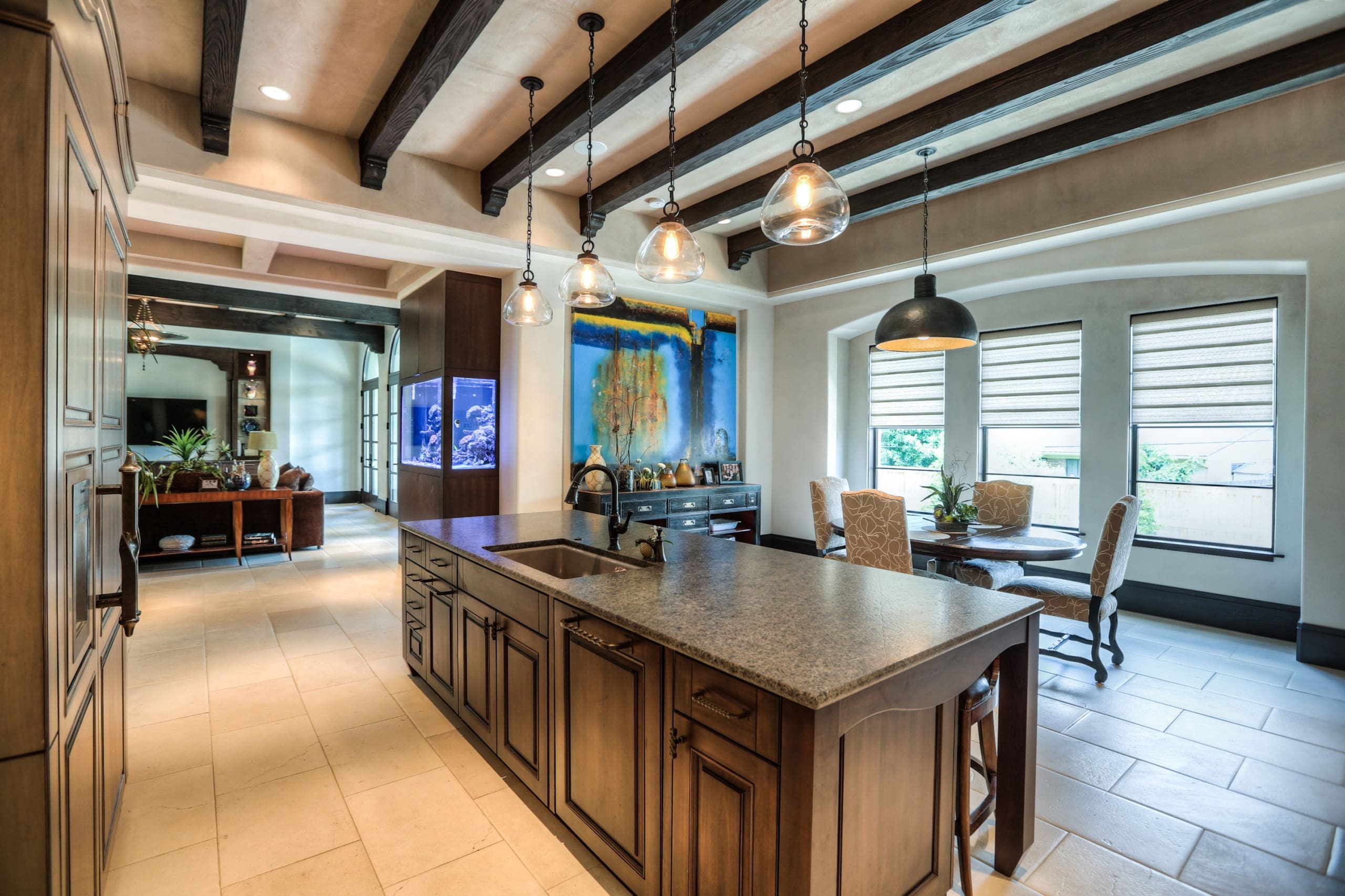 Modern kitchen with island and dining area.