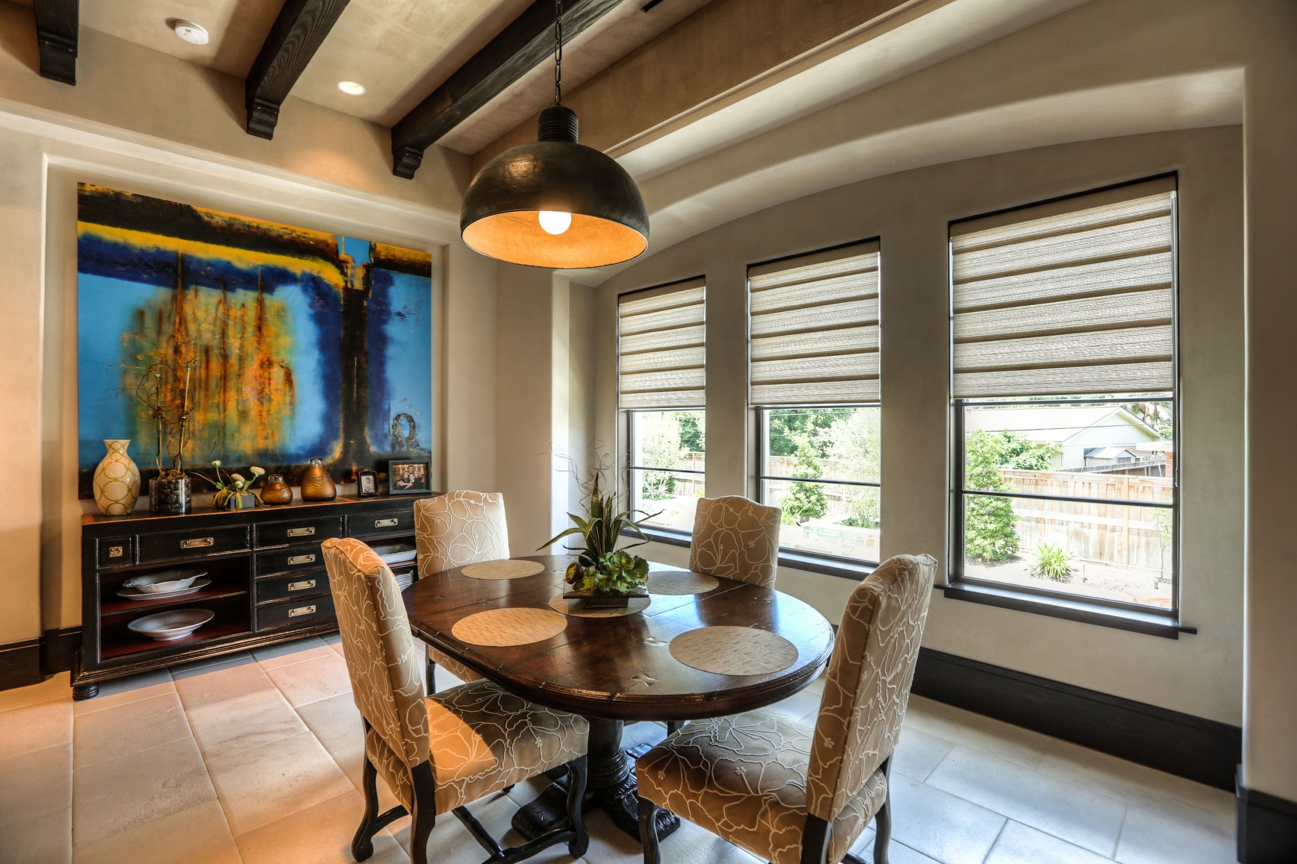 Dining room with table and abstract painting.