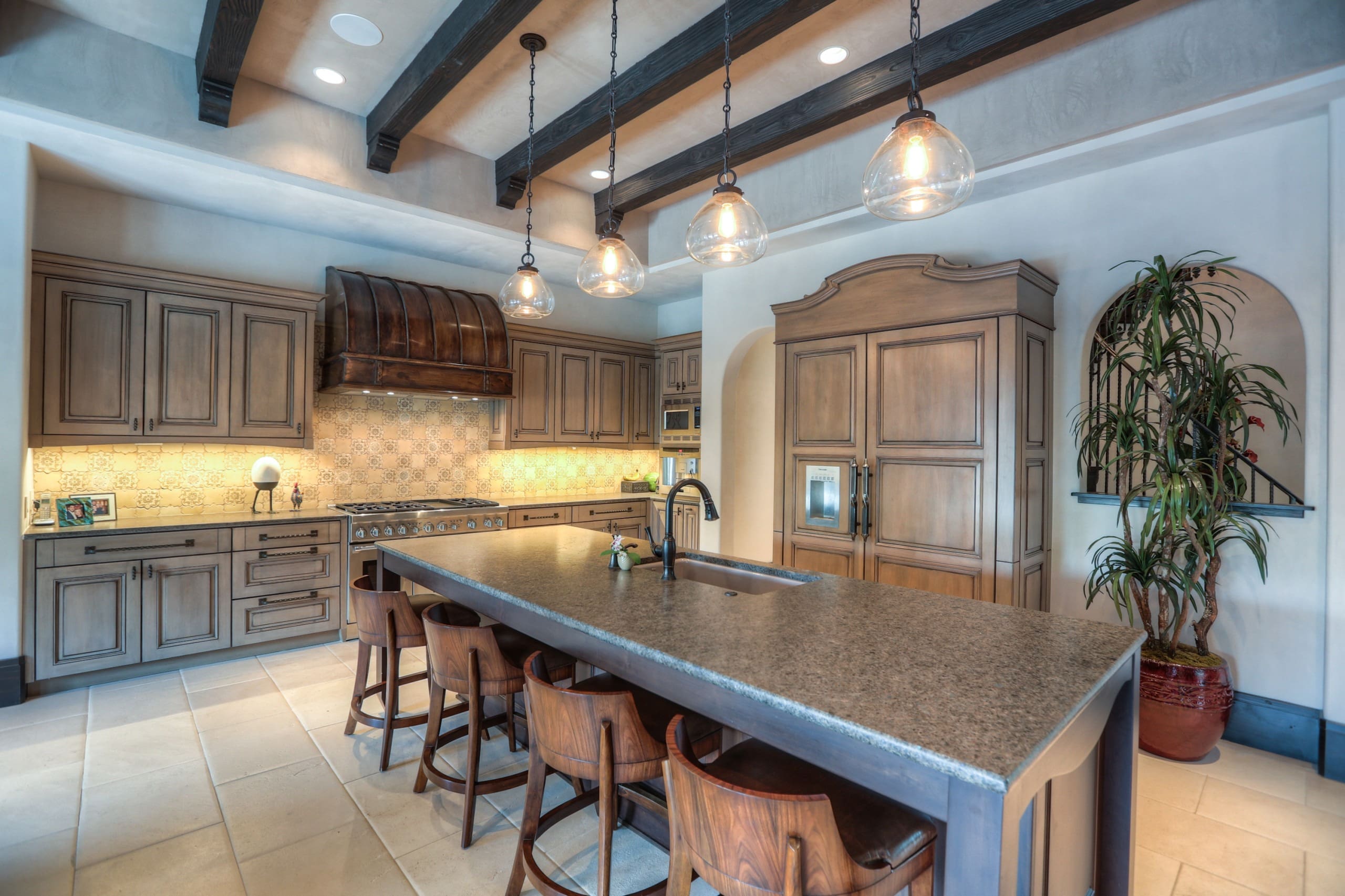 Rustic kitchen with wooden cabinets and island.