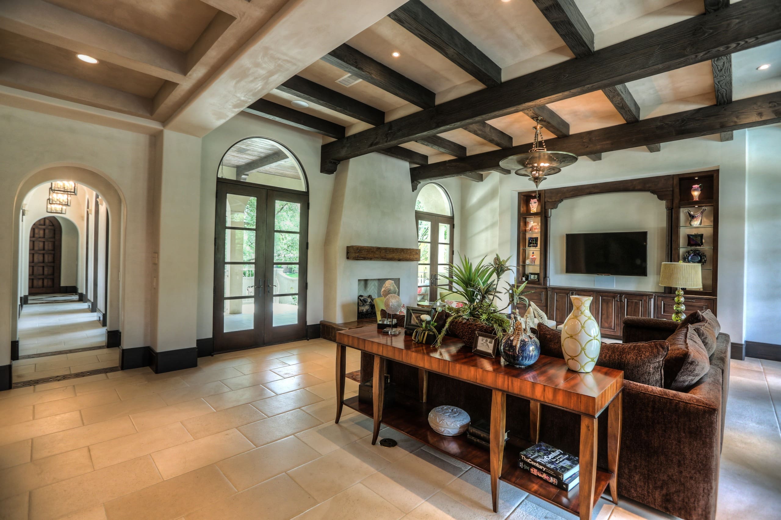 Spacious living room with wooden ceiling beams.