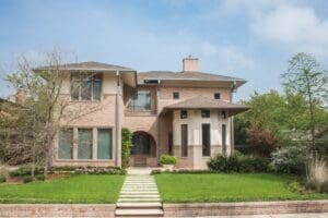 Two-story brick house with green lawn