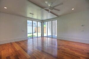 Spacious room with wooden floor and windows