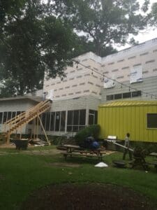 Workers renovating house exterior facade