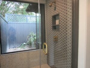 Modern shower with hexagonal tiles and window