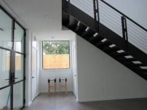 Bright hallway featuring sleek staircase design